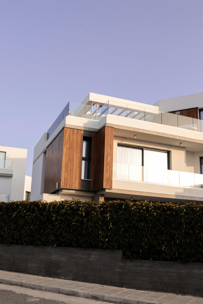 Contemporary white and wooden villa exterior shot at daytime with elegant design.